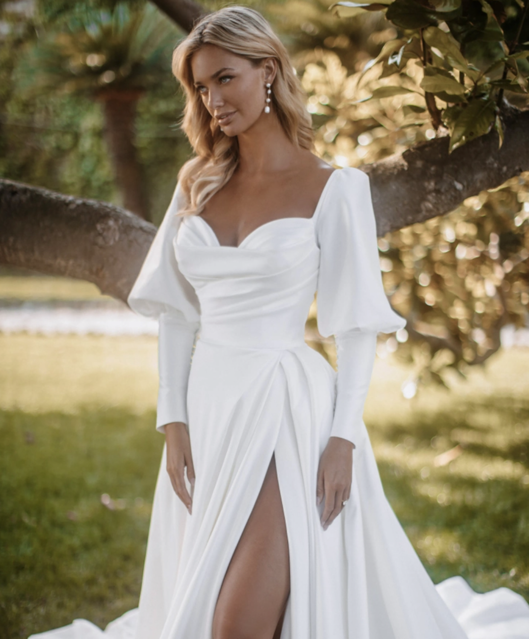 Model wearing a white gown by Abella